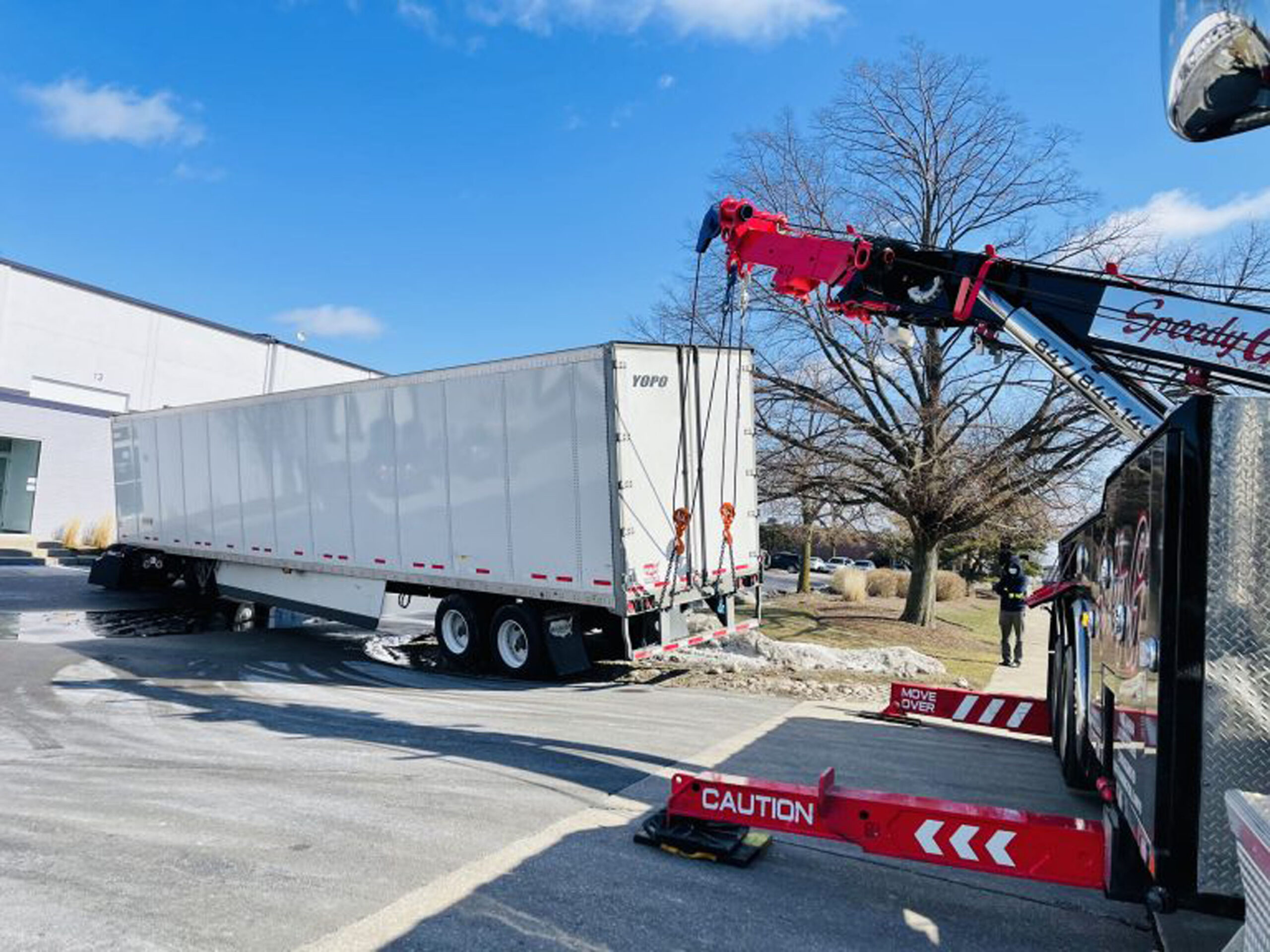 Speedy G truck rescuing a trailer from a snow bank