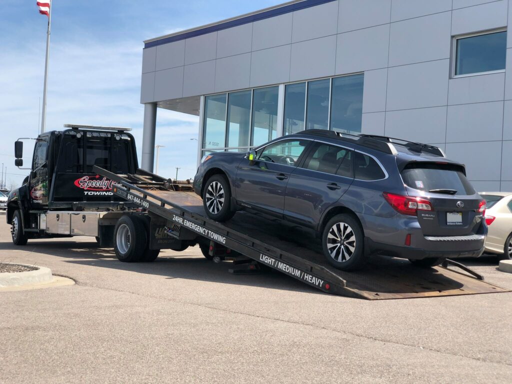 Speedy G truck towing an SUV