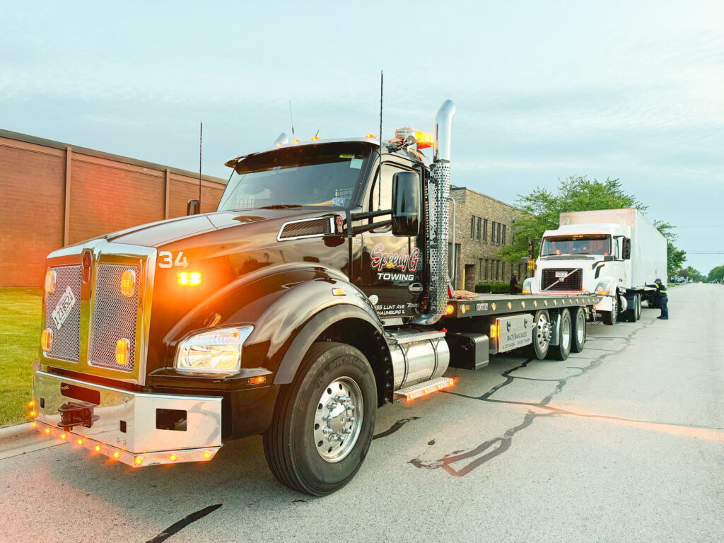 Speedy G truck towing an 18 wheel truck