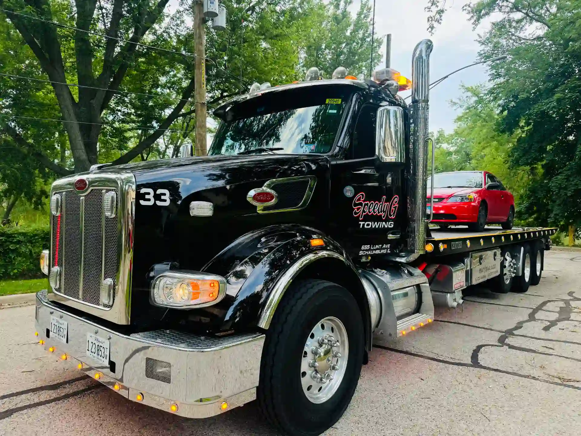 peterbilt-flatbed-tow-truck-hauling-sedan-schaumburg-il
