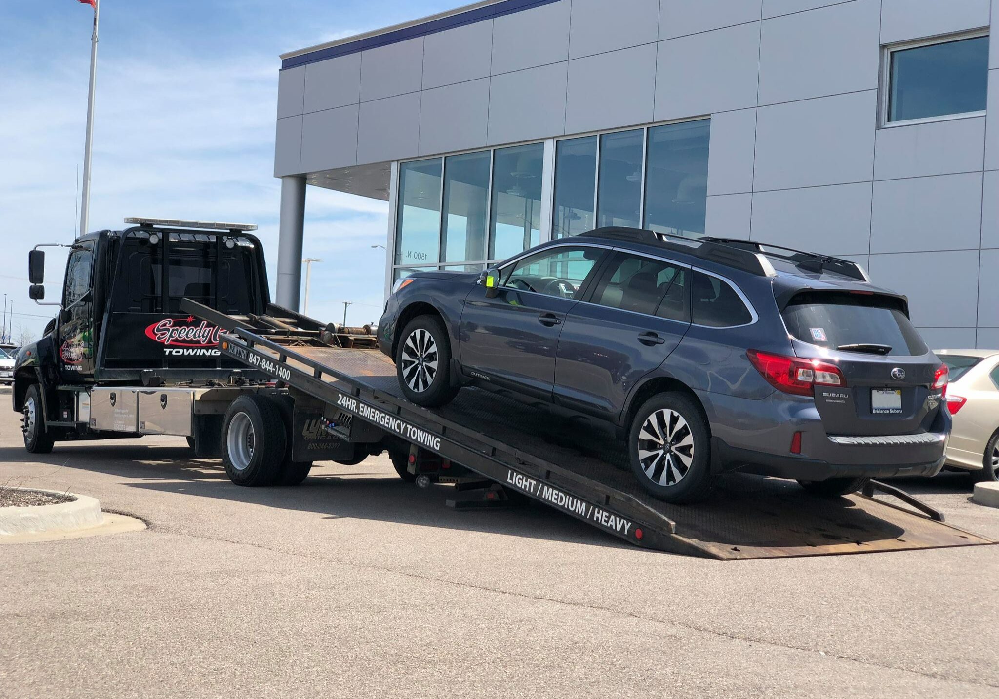 Speedy G truck towing an SUV