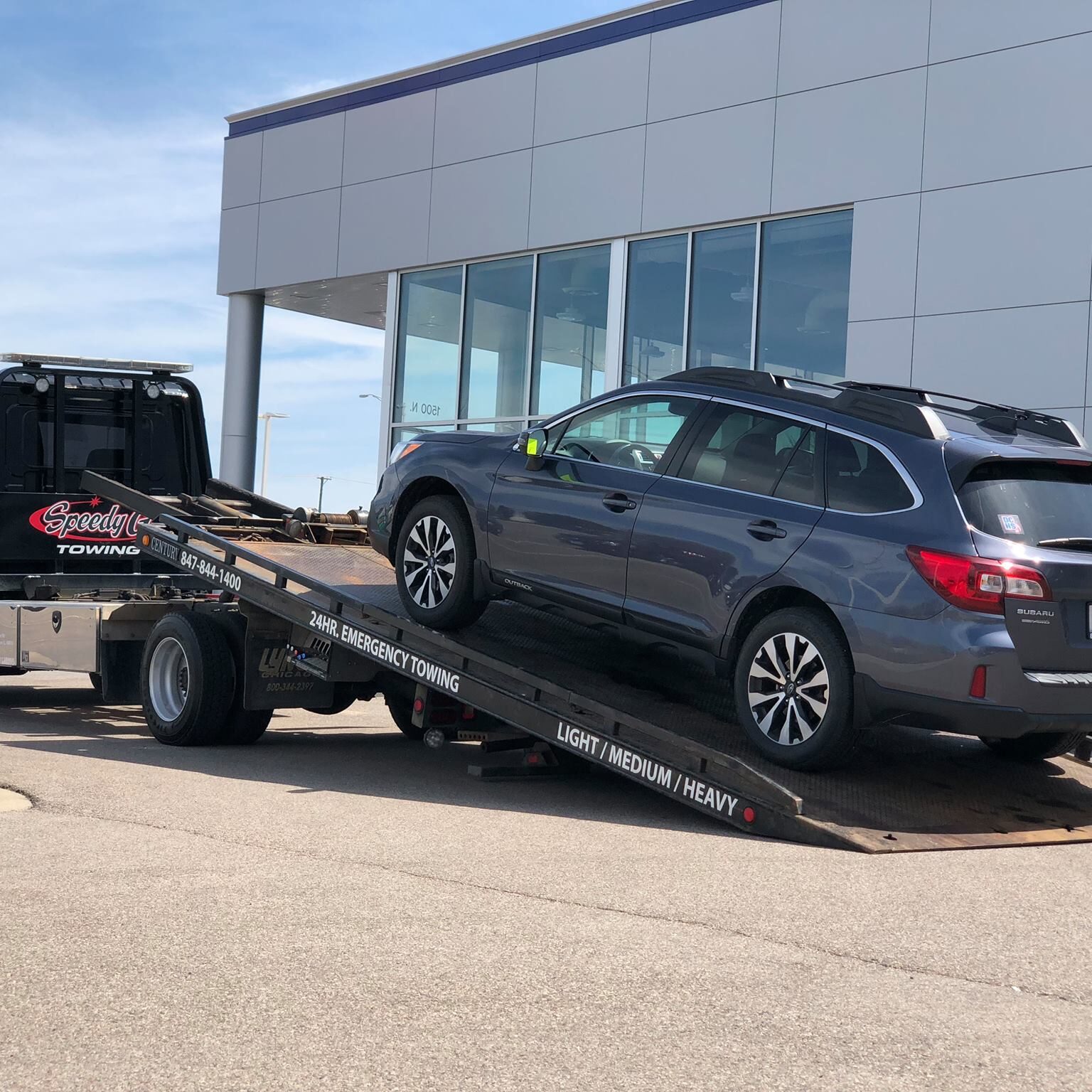 Speedy G truck towing an SUV