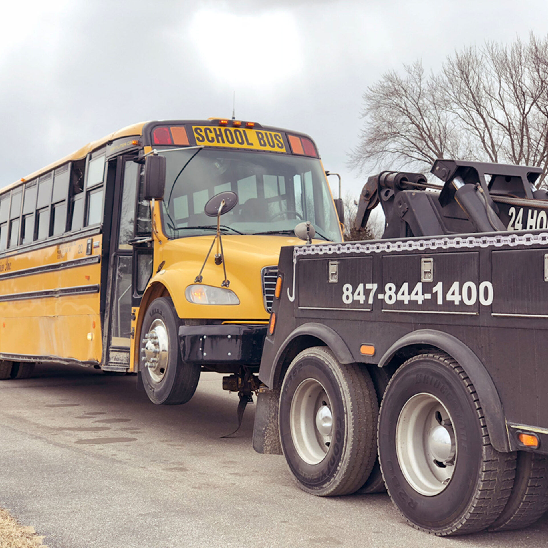 Speedy G truck towing a school bus